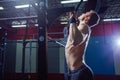 Athlete muscular fitness male model pulling up on horizontal bar in a gym. Cross fit style Royalty Free Stock Photo