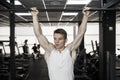 Athlete muscular fitness male model pulling up on horizontal bar in a gym Royalty Free Stock Photo