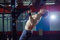 Athlete muscular fitness male model pulling up on horizontal bar in a gym. Cross fit style Royalty Free Stock Photo