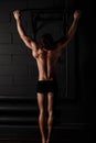 Athlete muscular fitness male model pulling up on horizontal bar Royalty Free Stock Photo