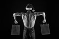 Athlete muscular man wear santa hat and apron. I have gift for you. Macho muscular torso posing with shopping bags Royalty Free Stock Photo