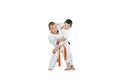 An athlete with an orange belt makes a grab for the throw