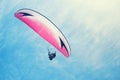 Athlete paragliding against the background of blue sky and clouds