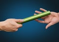 Athlete passing baton against blue background Royalty Free Stock Photo