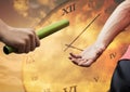 Athlete passing the baton to teammate against clock background Royalty Free Stock Photo