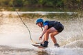 An athlete performs a trick on the water. Park at sunset. Wakeboard rider Royalty Free Stock Photo