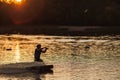 An athlete performs a trick on the water. Park at sunset. Wakeboard rider Royalty Free Stock Photo