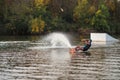 An athlete performs a trick on the water. Park at sunset. Wakeboard rider Royalty Free Stock Photo