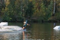 An athlete performs a trick on the water. Park at sunset. Wakeboard rider Royalty Free Stock Photo