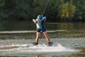 An athlete performs a trick on the water. Park at sunset. Wakeboard rider Royalty Free Stock Photo