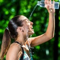 Athlete pouring cold water on face after jog. Royalty Free Stock Photo