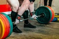 athlete powerlifter performing deadlift heavy barbell at powerlifting competition