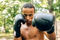 Athlete practicing punches outdoors on sports ground