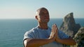 Athlete practicing yoga ocean view. Focused man meditating in namaste position Royalty Free Stock Photo