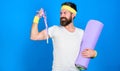 Athlete professional coach motivated for training. Athlete wear bandages for sweat. Man bearded athlete hold fitness mat