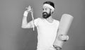 Athlete professional coach motivated for training. Athlete wear bandages for sweat. Man bearded athlete hold fitness mat