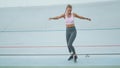 Athlete with prosthetic leg jumping sideways on track. Girl training at stadium Royalty Free Stock Photo