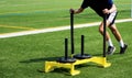 Athlete pushing a sled with weights on a turf field Royalty Free Stock Photo