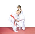 The athlete with the red belt makes capture leg