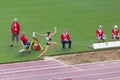 Athlete and referees on triple jump Royalty Free Stock Photo