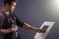 Athlete regulating intensity of ems electro muscular stimulation machine Royalty Free Stock Photo