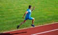 Athlete run track grass background. Sprinter training at stadium track. Runner captured in midair. Short distance