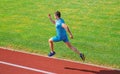 Athlete run track grass background. Sprinter training at stadium track. Runner captured in midair. Short distance