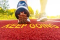 Athlete runner feet and message KEEP GOING Royalty Free Stock Photo