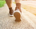 Athlete runner feet running in nature, close up on black shoe. men fitness jogging on the public, active lifestyle concept Royalty Free Stock Photo