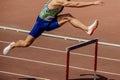 athlete runner running 400 metres hurdles is track and field hurdling event