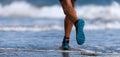 Athlete runner running on waves of sea Royalty Free Stock Photo