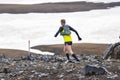 Athlete runners run a mountain marathon in the snowy terrain of Landmannalaugar. Iceland