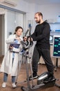 Athlete running on cross trainer in sport science laboratory