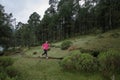 Athlete running outdoors near a lake