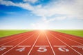 Athlete running track with number on the start. Day scene Royalty Free Stock Photo