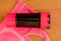 Athlete`s set with a bottle of water over a pink sport bra on wooden background Royalty Free Stock Photo