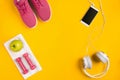 Athlete`s set with female clothing, dumbbells and bottle of water on yellow background Royalty Free Stock Photo