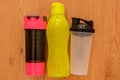 Athlete`s set with three bottles of water, in a row on wooden background Royalty Free Stock Photo