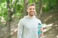 Athlete satisfied face hold bottle care hydration body after workout. Refreshing vitamin drink after great workout. Man Royalty Free Stock Photo