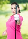 Athlete shows a golf club at the camera