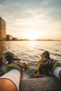 Athlete sits on a wooden pier after a roller skating ride and watches the sunset in Almere, Netherlands Royalty Free Stock Photo