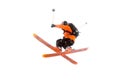 The athlete skier in the orange black suit does the jump trick by crossing the skis. real photo made in the mountains