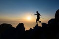 Athlete skyrunner in silhouette on the downhill rocks Royalty Free Stock Photo