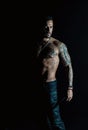 Athlete or sportsman with muscular chest and belly. Tattoo model with six pack and ab. Bearded man with tattooed body