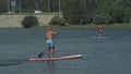 Athlete on stand up paddleboard sup holding paddle board up paddleboarding race. SUP surfboard.