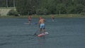 Athlete on stand up paddleboard sup holding paddle board up paddleboarding race. SUP surfboard.