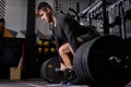 Athlete standing on his knee preparing to make deadlift at gym Royalty Free Stock Photo