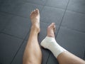 Athlete staring at her injured ankle Royalty Free Stock Photo