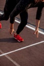 Athlete on starting position at running track. Runner practicing run in stadium racetrack