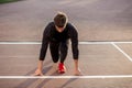 Athlete on starting position at running track. Runner practicing run in stadium racetrack Royalty Free Stock Photo